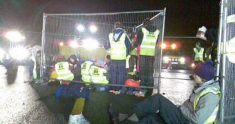 Protesters on the airport runway, chained to the tarmac