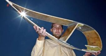 Purdue doctoral student Jonathan White holds a cross section of a wind turbine blade like the one used in research to improve the efficiency of turbines and prevent damage to blades from high winds