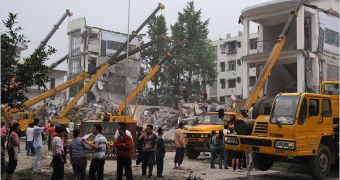 Chinese rescuers work to clear debris from a collapsed Chinese school