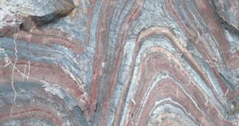 A banded iron formation about 2.5 billion years old, near Soudan Underground Mine State Park, in Minnesota, showing alternating layers of silica-rich (red) and iron-rich (gray) minerals
