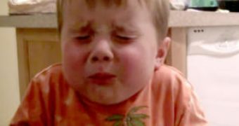 A 3-year-old's expression is priceless as he tries out Atomic Warhead candy