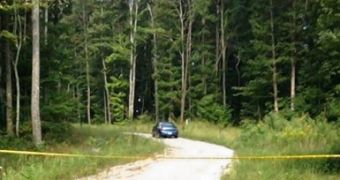 The bodies were found in a blue sedan in a wooded area
