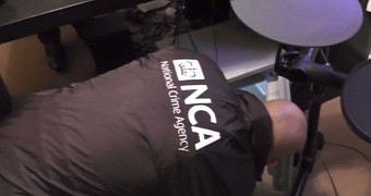 NCA officer searching the premises of a suspected malware developer