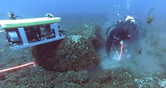 Diver and remotely operated vehicle collecting samples at ancient hunting site under Lake Huron