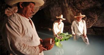 Leaves containing a mixture of a natural toxin and plaster are placed into tan underground river to numb fish