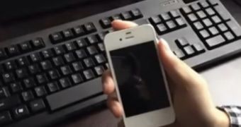 White iPhone against black keyboard background
