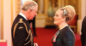 Adele looks nervous but happy as she receives her MBE from Prince Charles