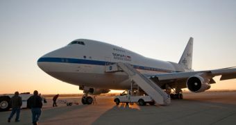 Ground crewmen approach NASA's SOFIA flying observatory shortly after the modified Boeing 747SP carrying a 2.5-meter telescope landed, following an all-night astronomical observation mission