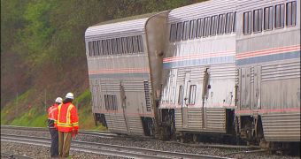 Three cars are left on the tracks after an Amtrak train derails during a mudslide