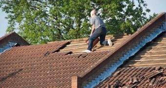 Furious man climbed on top of his roof and started throwing tiles into the street