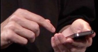 Steve Jobs holding iPhone 4 in what would be the "wrong" way to do it