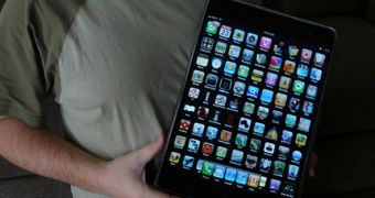 A person holding a fake Apple tablet designed to look like a big iPhone / iPod touch (cropped)