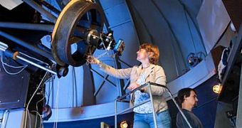University of Delaware astronomer Judi Provencial looks through the telescope at Mt. Cuba Observatory in Greenville, Del., while graduate student James Dalessio monitors data online