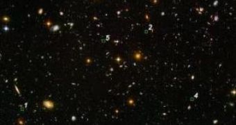 In this image of the Hubble Ultra Deep Field, several objects are identified as the faintest, most compact galaxies ever observed in the distant Universe.