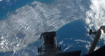In this picture snapped by an Atlantis crew member, the tip of the Hubble Space Telescope is seen in profile over an image of the Florida Peninsula