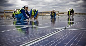 Workers installing Installing solar panels at the FedEx hub in the US