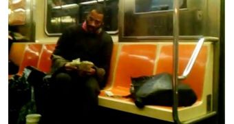 Jeffrey Hillman counts bills on a train in NYC