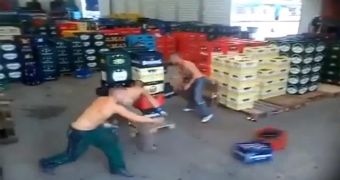 A team of workers sorts through a pallet of beer