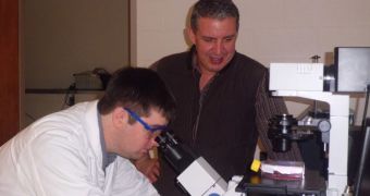 Chemistry professor Dana Spence, right, is seen working in his lab with a graduate student