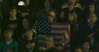 Fans sing the national anthem during the Bruins-Sabres game