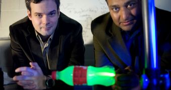 Velten, left, and Ramesh Raskar with the experimental setup they used to produce slow-motion video of light scattering through a plastic bottle