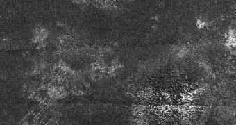 In this synthetic aperture radar image obtained by Cassini, two generally similar features, upper center and lower right, appear to be low mountains with grooves running roughly in the up-down direction