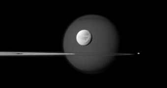 A quartet of Saturn's moons, from tiny to huge, surround and are embedded within the planet's rings in this Cassini composition
