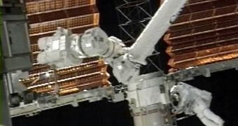 In this image from NASA TV, mission specialist Steve Swanson is shown working on the retraction of the starboard solar array on the international space station, Wednesday, June 13, 2007.