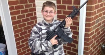 11-year-old poses in camouflage, holds rifle