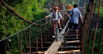 Children cycle to school on suspended aqueduct