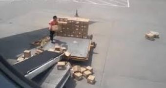 An airport freight handler in China fails at loading boxes onto a plane