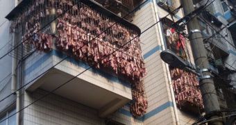 Chinese resident hangs pounds of meat on balcony