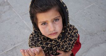 A young Afghan girl begging in the street in Kabul, in 2008
