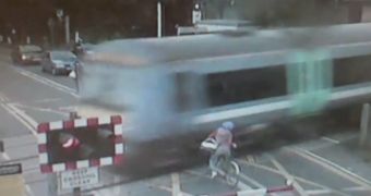 Cyclist rides too close to the train tracks in Waterbeach, England