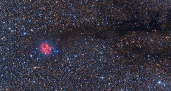 This is the Cocoon Nebula, its trail of destruction clearly visible spanning to the right of the image