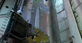 Image of the Columbus module while being loaded in the cargo bay of Atlantis space shuttle