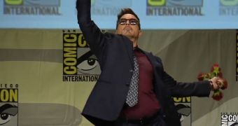 Robert Downey Jr. knows how to make an entrance: he threw flowers at fans on Marvel panel at Comic-Con 2014