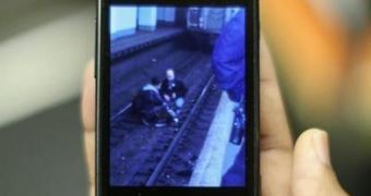 A woman lies on the tracks in a Brooklyn train station