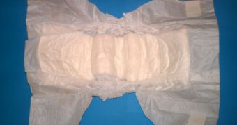 Disposable baby diaper with resealable tapes and elasticated leg cuffs.