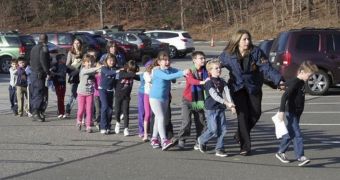 Children are being led out of the elementary school in Connecticut where 27 people were shot and killed today