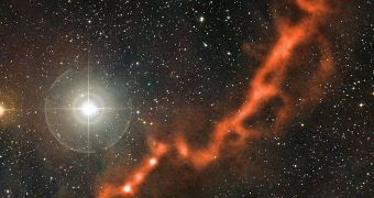 This image from the APEX telescope, a part of the Taurus Molecular Cloud, shows a sinuous filament of cosmic dust more than ten light-years long