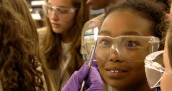 Members of Girl Scouts of America Troop 25080 of Houston look at fresh graphene, just out of the furnace and attached to a piece of copper