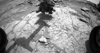 Curiosity applying pressure to its drill and arm