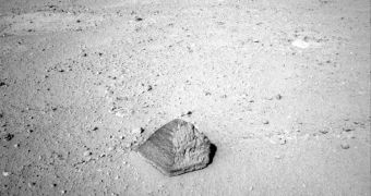 Curiosity has driven up to a football-size rock that will be the first for the rover's arm to examine