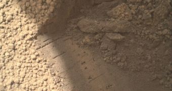 The "bite" left by Curiosity's scoop in the Martian soil revealed more shiny particles
