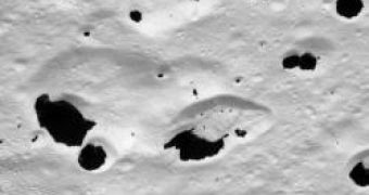 Dark splotches are mainly found on the sunward-facing slopes of craters on Iapetus