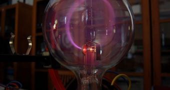 Beam of electrons moving in a circle in a magnetic field (cyclotron motion). Lighting is caused by the excitation of atoms of gas in a bulb