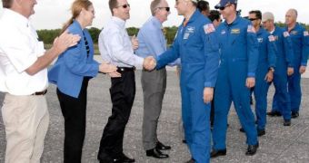 NASA officials greet the Discovery crew, as its members descend from the Discovery space shuttle