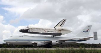 Discovery, mounted atop its SCA, lands at its KSC air strip early on Monday, September 22nd