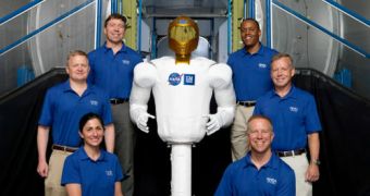 The six members of the STS-133 crew, seen here posing with Robonaut-2
